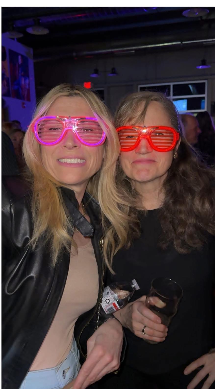 Two friends posing with fun retro shutter shade glasses
